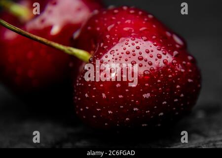 Close up of fresh, healthy and wet sweet cherry berry with water drops on it. Stock Photo