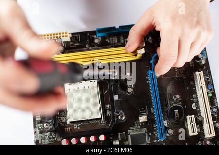 Technological background with closeup on tester checking motherboard. Toned image. Shallow DOF Stock Photo