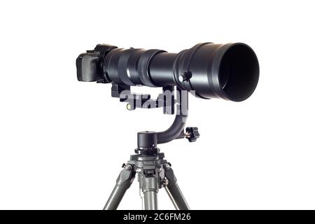 Horizontal shot of of a digital camera on a tripod with a super telephoto lens isolated on white. Stock Photo