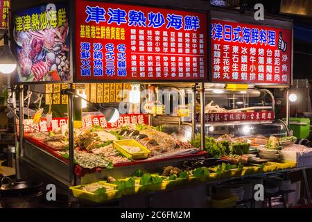 Taipei, Taiwan - Dec. 24th, 2018: A seafood stall at Guangzhou Street Night Market in Taipei's oldest district Wanhua offers a wide range of fish and Stock Photo