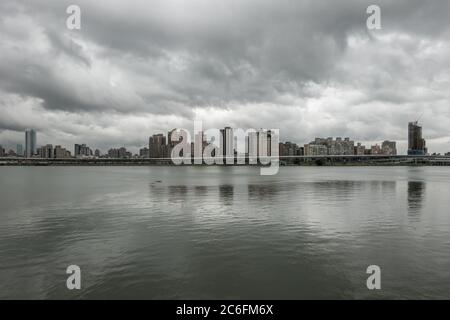 Taipei grey weather view from Dadaocheng Dock towards Sanchong district with buildings in a modern as well as functional architectural style Stock Photo