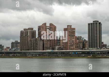 Taipei grey weather view from Dadaocheng Dock towards Sanchong district with buildings in a modern as well as functional architectural style Stock Photo
