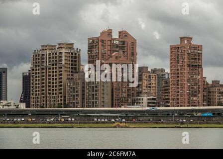 Taipei, Taiwan - December 23rd, 2018: A grey weather view from Dadaocheng Dock towards Sanchong district with it's skyscrapers following a modern, fun Stock Photo