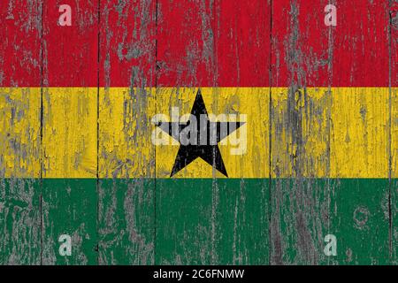 Ghana flag on grunge scratched wooden surface. National vintage background. Old wooden table scratched flag surface. Stock Photo