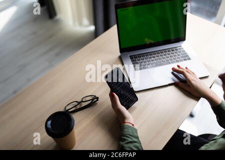 close up of business womans hand typing on laptop at modern startup office computer Stock Photo