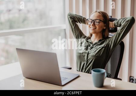 Portrait of relaxed business woman in office Stock Photo