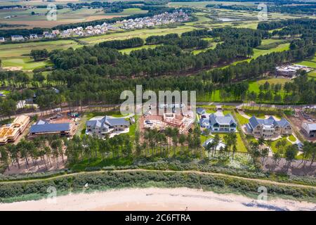 Aerial view of modern large luxury houses on coast at exclusive Archerfield estate in East Lothian, Scotland, UK Stock Photo