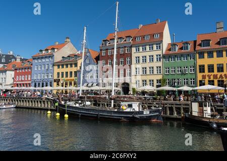 Hotels, restaurants, boats and people on the waterfront district, Nyhavn, Copenhagen, Denmark, Scandinavia, Europe Stock Photo