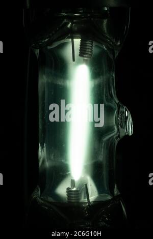 A Japanese made Iwasaki 'EYE' 50W clear mercury lamp showing a close up of the arc tube after warm up. Mercury vapour lamp, HID, lighting Stock Photo