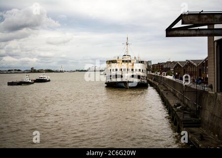 A forlorn Royal Iris ferry sits on the banks of the River Thames, in derelict condition, rusting away and awaiting her fate Stock Photo