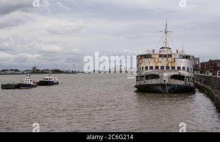 A forlorn Royal Iris ferry sits on the banks of the River Thames, in derelict condition, rusting away and awaiting her fate Stock Photo