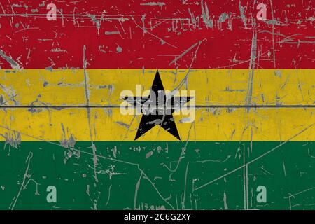 Ghana flag painted on cracked dirty surface. National pattern on vintage style surface. Scratched and weathered concept. Stock Photo