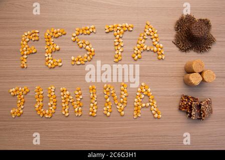 June party (Festa Junina) written with corn grains on wood. Traditional Brazilian festival celebrated between June and July. Country party with typica Stock Photo