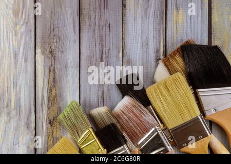 Various paint tools brush for home renovation on wooden table background Stock Photo
