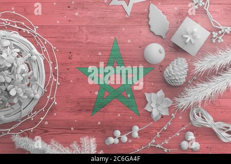 Morocco flag on wooden table with snow objects. Christmas and new year background, celebration national concept with white decor. Stock Photo