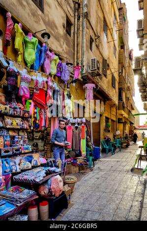 Merchant stands outside his shop in one of many side streets of the Khan El Khalili market in Old Cairo Stock Photo