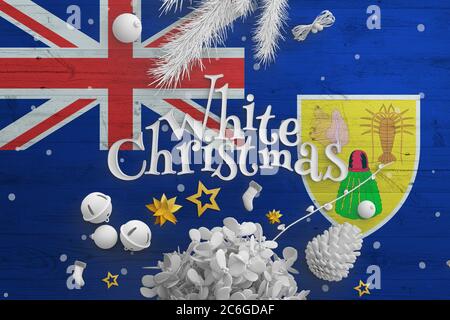 Turks And Caicos Islands flag on wooden table with White Christmas text. Christmas and new year background, celebration national concept with white de Stock Photo