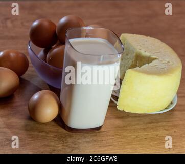 Image of edible food with a glass of milk, cheese and eggs. Breakfast ingredients. farm products. Human food. Brazilian cuisine. Stock Photo