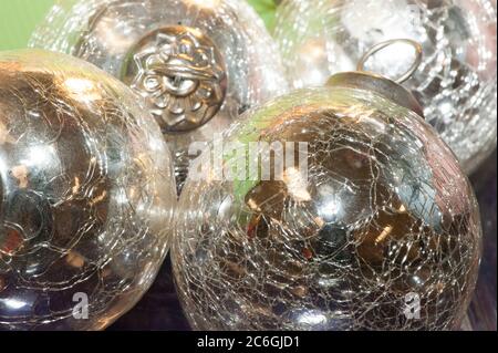Bright, shiny, silver-colored metallic balls or Christmas decorations are viewed close-up and in a small grouping. Stock Photo