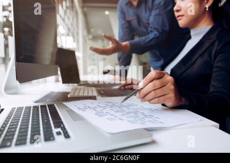 Two asian team working development of programming and encryption technology website design programmers on desk in office. Stock Photo