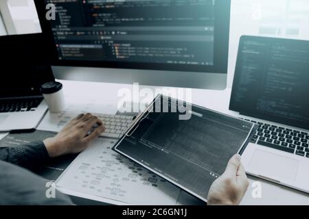 Asian man working code program developer computer web development working design software on desk in office. Stock Photo