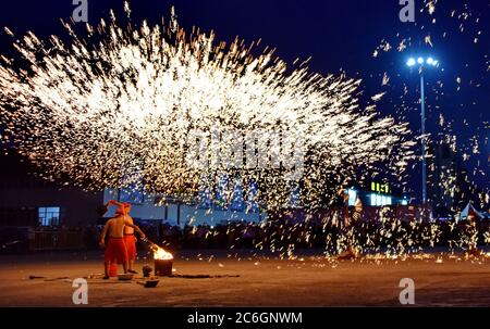 Artists perform molten iron splash near Qinggang highway interchange in Changchun city, northeast China's Jilin province, 7 June 2020. Stock Photo