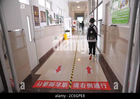 Walking direction signs are put on the floor for students to keep social distance in a junior high school in Harbin city, northeast China's Heilongjia Stock Photo