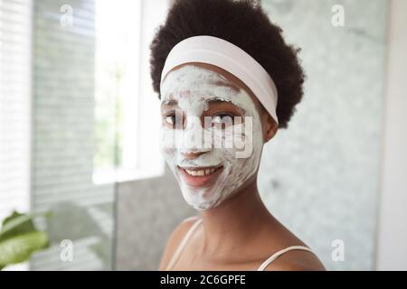 Portrait of a mixed race woman spending time at home self isolating and social distancing in quarantine lockdown during coronavirus covid 19 epidemic, Stock Photo