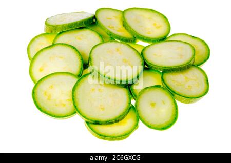 Round slices of young zucchini on white background.  Stock Photo