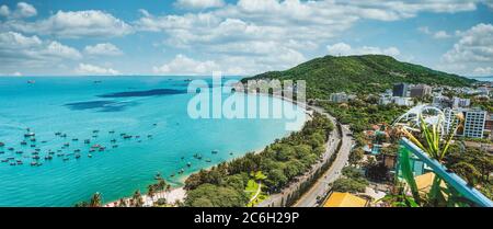 Panoramic coastal Vung Tau view from above, with waves, coastline, streets, coconut trees and Tao Phung mountain in Vietnam Stock Photo