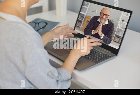 Senior man makes a video call chat using laptop technology webcam application at home. Stock Photo
