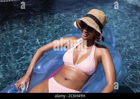 Woman floating on inflatable ring in the pool Stock Photo