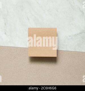 Brown kraft memo pad, empty paper on gray and brown background. top view, copy space Stock Photo