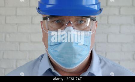 Confident Image with an Engineer Wearing Face Protection Mask Against Viruses. Stock Photo