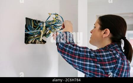 Electrician working on the electrical installation of a house Stock Photo