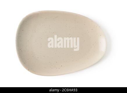 Empty oval beige ceramic plate isolated on a white background. Modern clay, ceramics or porcelain crockery and tableware. Top view. Stock Photo