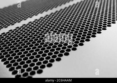 Close-up, shallow focus of a meshed style cooling panel used on a main frame computer, housed in a  data centre. The honeycomb holes aid venting. Stock Photo