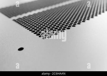 Close-up, shallow focus of a meshed style cooling panel used on a main frame computer, housed in a  data centre. The honeycomb holes aid venting. Stock Photo