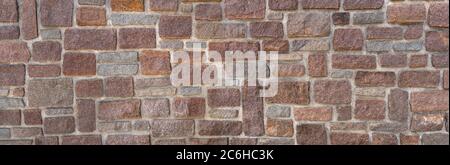 Old wall made of red and gray sandstones Stock Photo