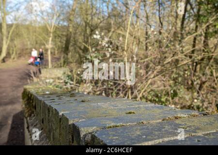 Close-up image of an old and weathered brick built foot bridge crossing. Stock Photo