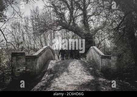 Close-up image of an old and weathered brick built foot bridge crossing. Stock Photo