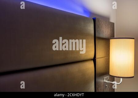 Shallow focus of modern LED ambient mood lighting seen in a modern apartment bedroom. The soft lighting acts to create a relaxing atmosphere. Stock Photo