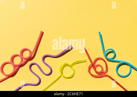 Set of Spiral multicolor cocktail tubes, isolated on yellow background.party drinking straw.Colorful cocktail. Concept of parties, celebrations. Copy Stock Photo
