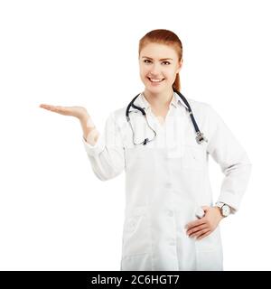 Portrait of a young female doctor in a white coat holding in hands anything against a white background. Doctor holding anything isolated on white back Stock Photo