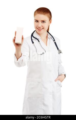 Portrait of a young female doctor in a white coat holding in hands a box with a new drug against a white background. Doctor holding an empty box with Stock Photo