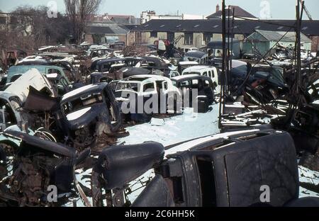 1963. An interesting motor car breaker's yard in wintertime. Most of the vehicles date from the 1930s and 1940s. Stock Photo
