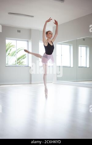 Female ballet dancer practicing dance at ballet class Stock Photo
