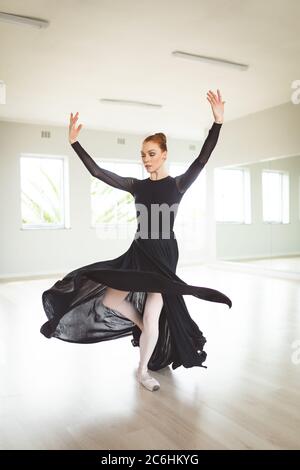 Female ballet dancer practicing dance at ballet class Stock Photo