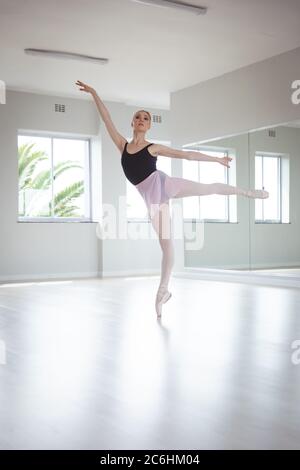 Female ballet dancer practicing dance at ballet class Stock Photo