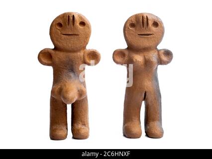 Ancient clay male and female figurines from Canary Islands isolated on white background Stock Photo